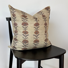 Load image into Gallery viewer, Decorative pillow with floral pattern on a black chair against a white background
