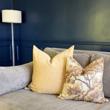 Load image into Gallery viewer, Decorative pillows on a sofa against a dark blue wall with a lamp in the background.