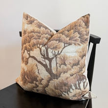 Load image into Gallery viewer, Decorative pillow with tree pattern on a black chair against a white background
