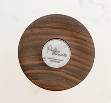 Load image into Gallery viewer, bottom of candle holder with logo coin on white background