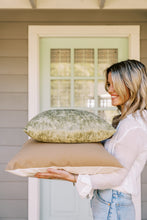 Load image into Gallery viewer, woman holding two pillows in front of a door