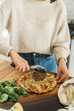 Load image into Gallery viewer, woman cutting pizza with pizza cutter