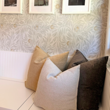 Load image into Gallery viewer, Decorative pillows on a sofa against a patterned wall.
