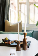 Load image into Gallery viewer, two walnut candleholders with charcuterie in background 
