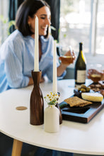 Load image into Gallery viewer, candle holders and flowers with charcuterie and woman in back
