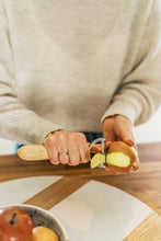 Load image into Gallery viewer, woman peeling apple 
