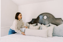 Load image into Gallery viewer, woman putting pillows on bed
